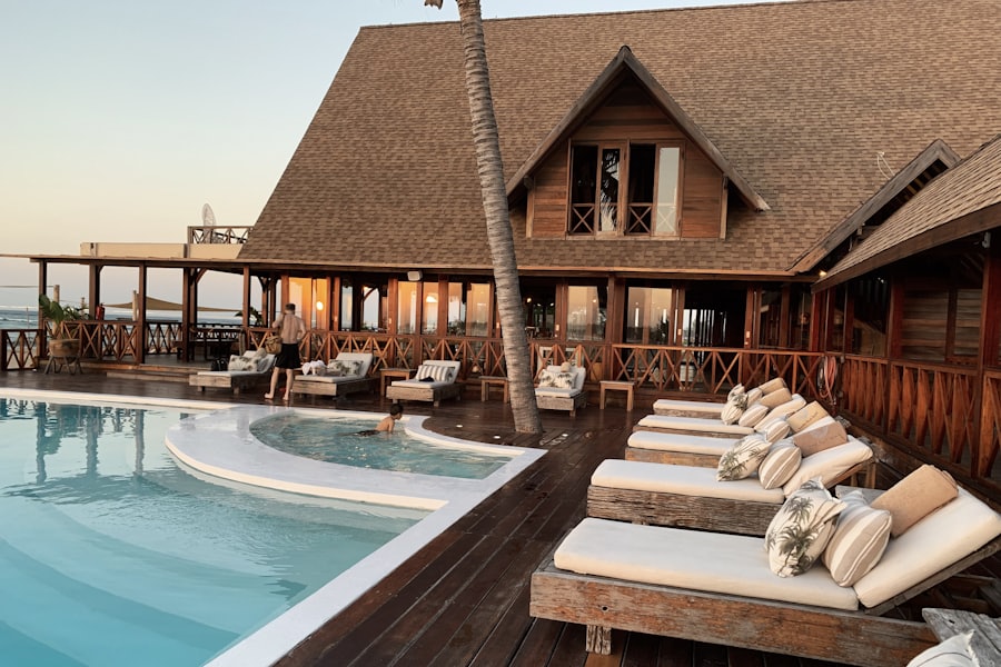 The hotel pool at dusk, loungers set out along the water.